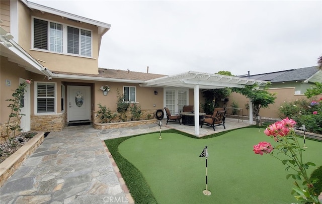 16671 Cedar Cir, Fountain Valley, CA 92708 - rear view of house featuring a putting area, a patio area, a pergola, and stucco siding
