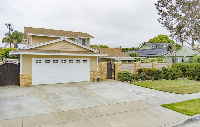 16671 Cedar Cir, Fountain Valley, CA 92708 - view of front of house featuring a gate, stone siding, driveway, and roof with shingles