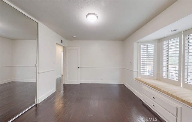 16671 Cedar Cir, Fountain Valley, CA 92708 - empty room featuring dark wood-style floors and a textured ceiling