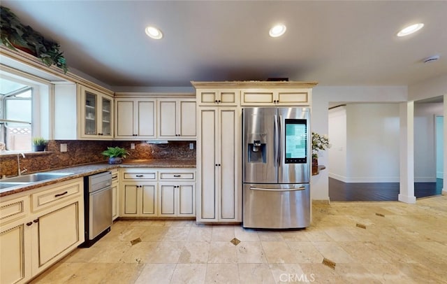 16671 Cedar Cir, Fountain Valley, CA 92708 - kitchen with stainless steel refrigerator with ice dispenser, cream cabinetry, decorative backsplash, dark countertops, and glass insert cabinets