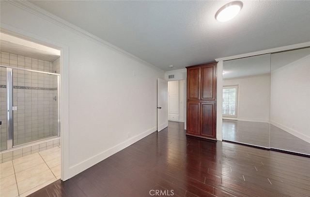 16671 Cedar Cir, Fountain Valley, CA 92708 - unfurnished bedroom with dark wood finished floors, crown molding, connected bathroom, and a closet