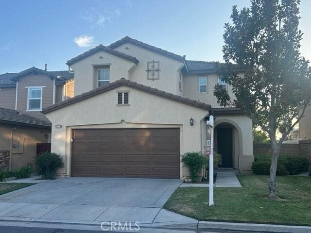 13120 Melon Ave, Chino, CA 91710 - mediterranean / spanish home featuring stucco siding, driveway, a front lawn, a tile roof, and a garage