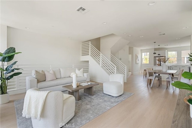 687 W 17th St, Costa Mesa, CA 92627 - living room featuring light wood-style flooring, recessed lighting, and stairway