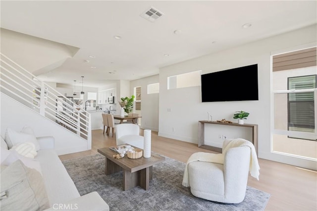 687 W 17th St, Costa Mesa, CA 92627 - living area featuring light wood-style flooring, recessed lighting, and stairway
