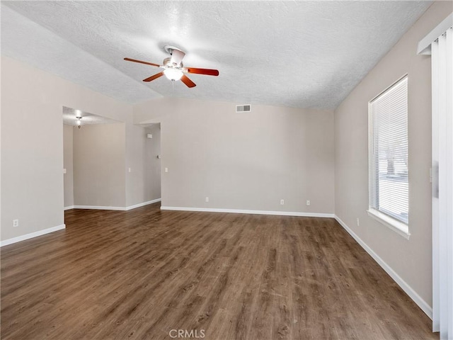 17702 Hinton St, Hesperia, CA 92345 - empty room with wood finished floors, ceiling fan, a textured ceiling, and vaulted ceiling