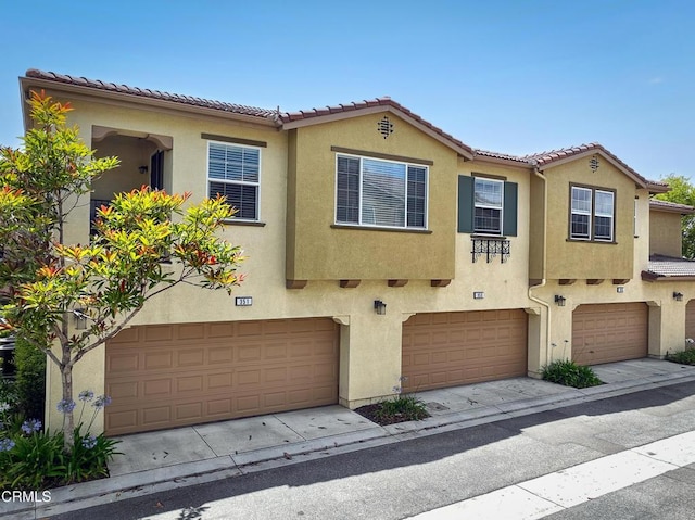 353 American River Ct, Oxnard, CA 93036 - view of property featuring stucco siding, an attached garage, and a tile roof