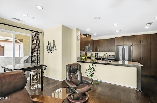 353 American River Ct, Oxnard, CA 93036 - kitchen featuring appliances with stainless steel finishes, dark brown cabinets, dark wood finished floors, a peninsula, and recessed lighting