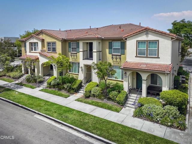 353 American River Ct, Oxnard, CA 93036 - view of front of property with a tile roof, stucco siding, covered porch, and stairway