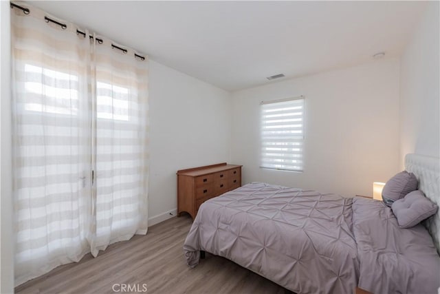 50 Tollson, Irvine, CA 92620 - bedroom with light wood-style flooring and baseboards