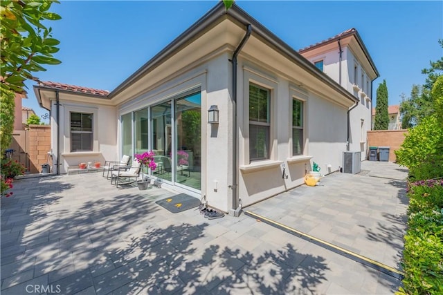 50 Tollson, Irvine, CA 92620 - rear view of house featuring a patio and stucco siding