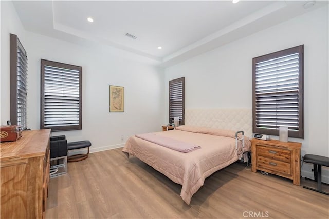 50 Tollson, Irvine, CA 92620 - bedroom with light wood-type flooring, a raised ceiling, recessed lighting, and multiple windows