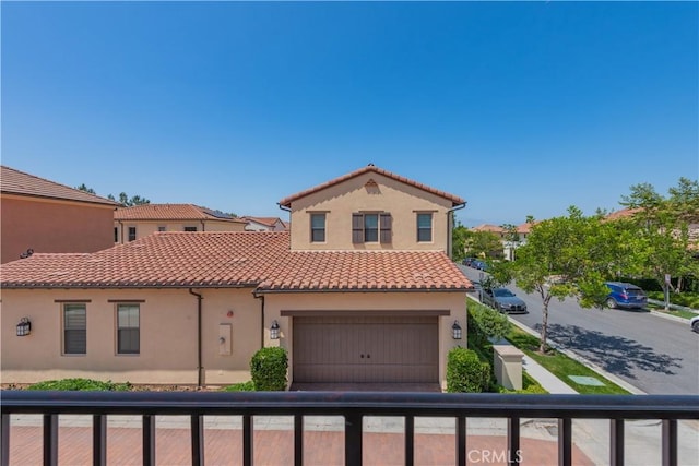 50 Tollson, Irvine, CA 92620 - mediterranean / spanish-style house featuring a tile roof, a balcony, and stucco siding