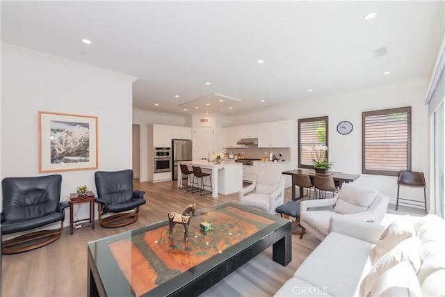 50 Tollson, Irvine, CA 92620 - living room with light wood-style flooring, recessed lighting, and crown molding
