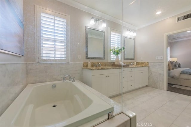 201 Bancroft, Irvine, CA 92620 - ensuite bathroom featuring double vanity, tile walls, a garden tub, crown molding, and wainscoting
