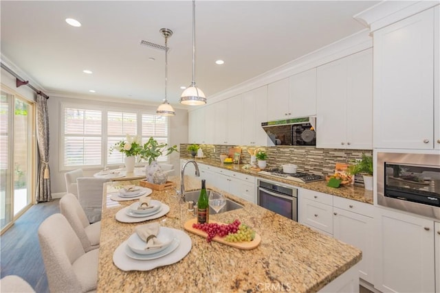 201 Bancroft, Irvine, CA 92620 - kitchen with stainless steel appliances, range hood, decorative backsplash, white cabinets, and recessed lighting