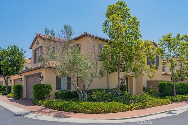 201 Bancroft, Irvine, CA 92620 - view of front facade with stucco siding, a garage, and a tile roof