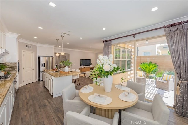 201 Bancroft, Irvine, CA 92620 - dining area with crown molding, dark wood-style floors, and recessed lighting
