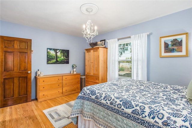 1107 Chestnut Ave, Redlands, CA 92373 - bedroom with wood finished floors and a chandelier