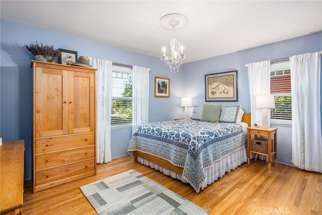 1107 Chestnut Ave, Redlands, CA 92373 - bedroom with a chandelier and light wood finished floors