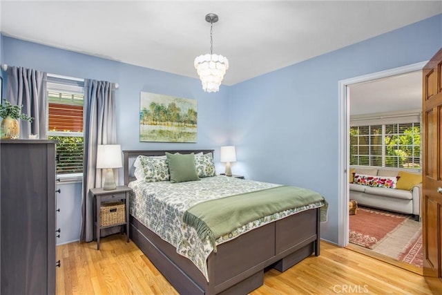 1107 Chestnut Ave, Redlands, CA 92373 - bedroom with light wood-style floors and a chandelier
