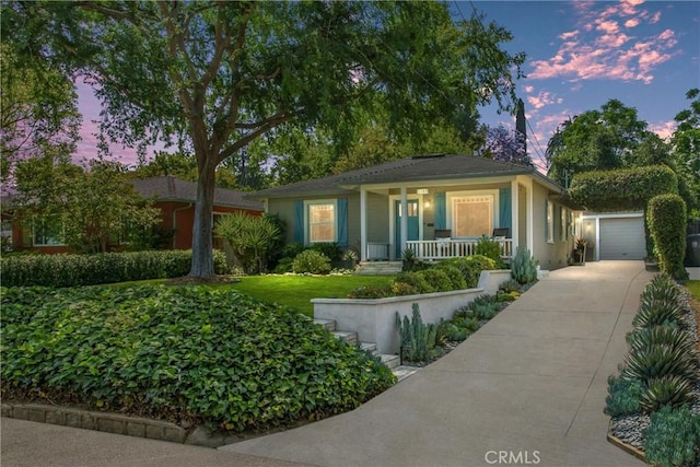 1107 Chestnut Ave, Redlands, CA 92373 - view of front of property featuring covered porch, an outbuilding, driveway, and stucco siding