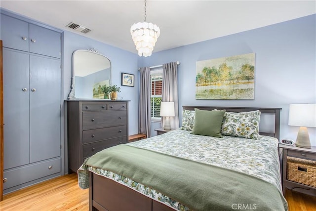 1107 Chestnut Ave, Redlands, CA 92373 - bedroom with a chandelier and light wood-style flooring