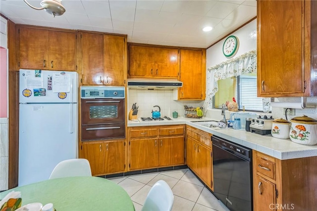 5437 Norwich Ave, Los Angeles, CA 90032 - kitchen with white appliances, a warming drawer, under cabinet range hood, light countertops, and brown cabinets