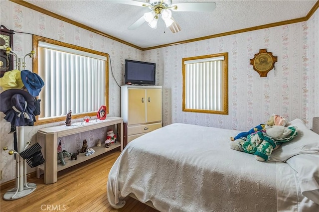5437 Norwich Ave, Los Angeles, CA 90032 - bedroom featuring ornamental molding, wood finished floors, wallpapered walls, a textured ceiling, and a ceiling fan