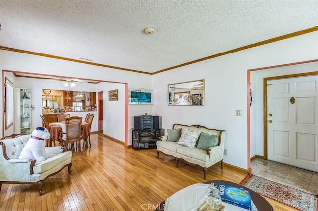 5437 Norwich Ave, Los Angeles, CA 90032 - living room with light wood finished floors, a textured ceiling, and ornamental molding