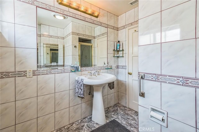 5437 Norwich Ave, Los Angeles, CA 90032 - bathroom featuring tile walls and marble finish floors