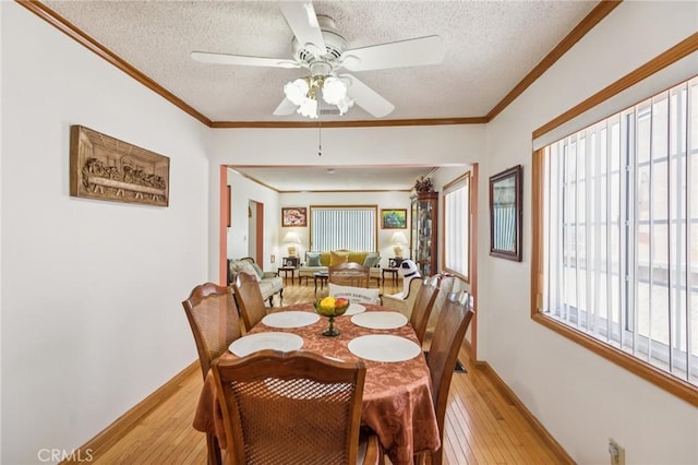 5437 Norwich Ave, Los Angeles, CA 90032 - dining room with light wood-type flooring, a textured ceiling, a ceiling fan, and ornamental molding