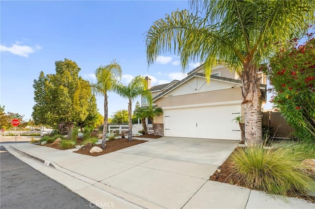 43611 Modena Dr, Temecula, CA 92592 - view of front facade with a garage, stucco siding, concrete driveway, and stone siding