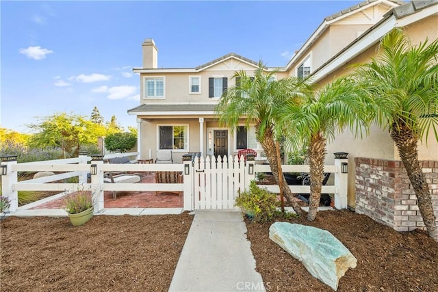 43611 Modena Dr, Temecula, CA 92592 - view of front facade featuring a gate, stucco siding, covered porch, and a fenced front yard