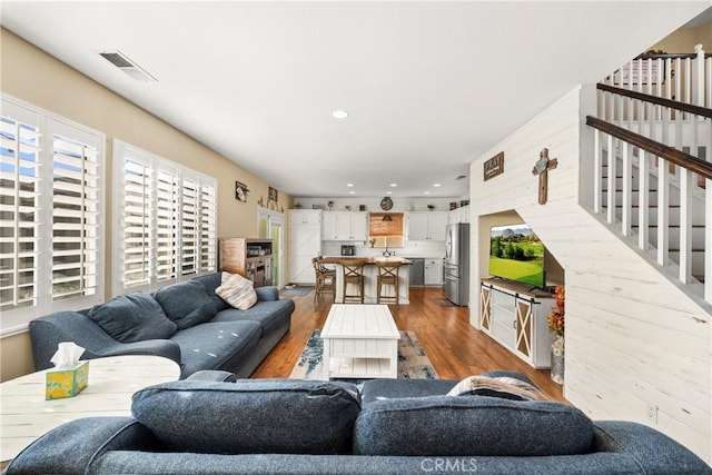 43611 Modena Dr, Temecula, CA 92592 - living area featuring wood finished floors, stairway, and recessed lighting