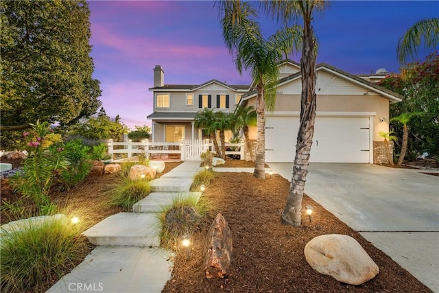 43611 Modena Dr, Temecula, CA 92592 - traditional home with stucco siding, concrete driveway, a garage, a chimney, and covered porch