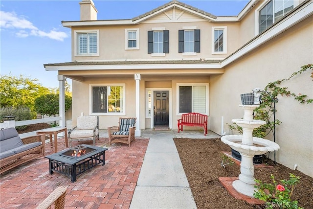 43611 Modena Dr, Temecula, CA 92592 - doorway to property featuring stucco siding, a chimney, and a patio area