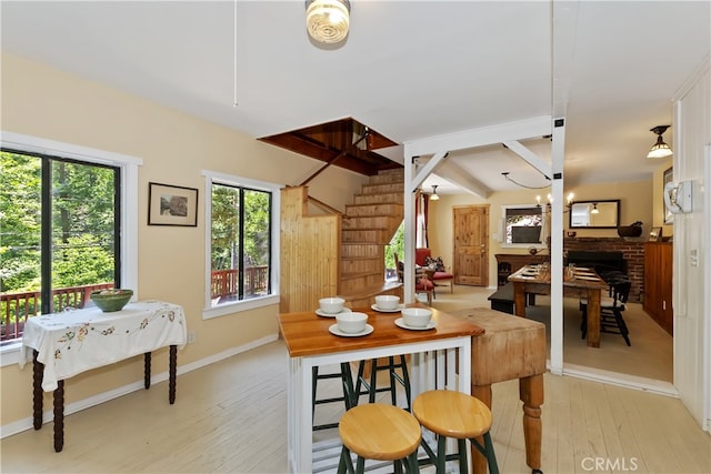 425 Blue Jay Canyon Rd, Blue Jay, CA 92317 - dining space featuring light wood finished floors, stairway, beamed ceiling, and a brick fireplace