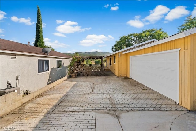 14526 Hardtree Dr, Lake Hughes, CA 93532 - garage featuring driveway and a mountain view