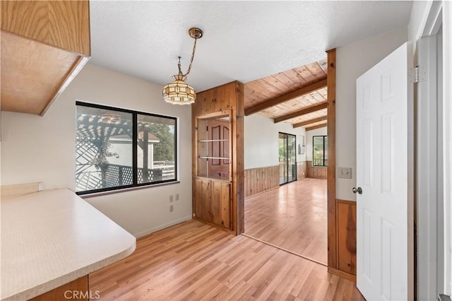 14526 Hardtree Dr, Lake Hughes, CA 93532 - unfurnished dining area featuring wooden walls, light wood-type flooring, and wainscoting