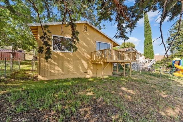 14526 Hardtree Dr, Lake Hughes, CA 93532 - back of property featuring a wooden deck and a playground