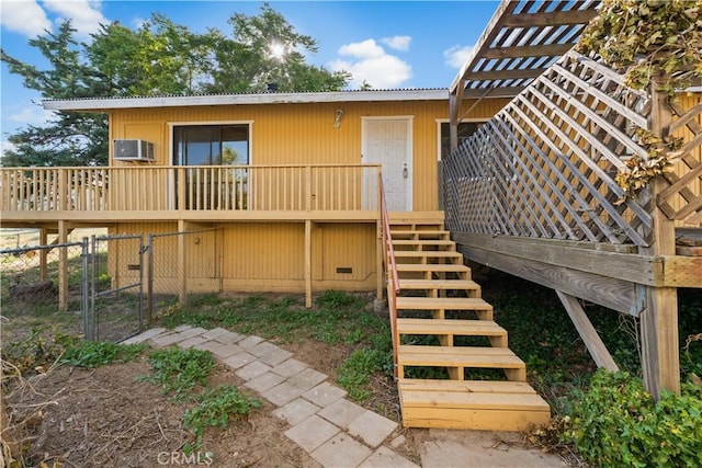 14526 Hardtree Dr, Lake Hughes, CA 93532 - rear view of property featuring stairway, a metal roof, a wooden deck, a wall unit AC, and a gate