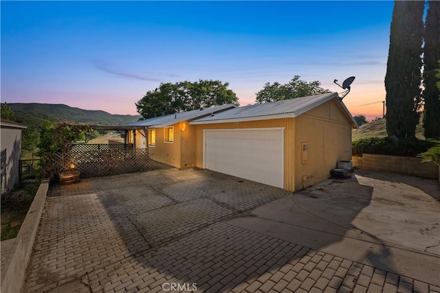 14526 Hardtree Dr, Lake Hughes, CA 93532 - view of front of home featuring an attached garage, decorative driveway, a mountain view, and a metal roof