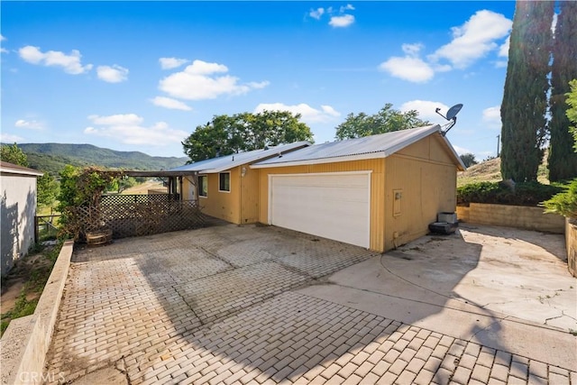 14526 Hardtree Dr, Lake Hughes, CA 93532 - garage featuring a mountain view and decorative driveway