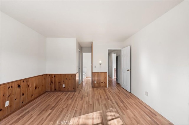 14526 Hardtree Dr, Lake Hughes, CA 93532 - empty room with light wood-style flooring, wainscoting, and wooden walls