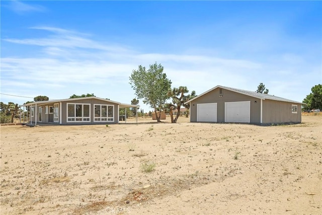 4369 Amador Rd, Phelan, CA 92371 - view of yard featuring a garage, an outdoor structure, and a sunroom