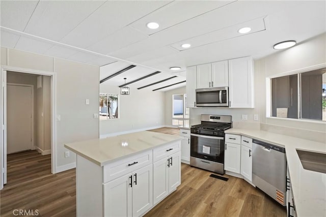 4369 Amador Rd, Phelan, CA 92371 - kitchen with stainless steel appliances, wood finished floors, white cabinets, and recessed lighting
