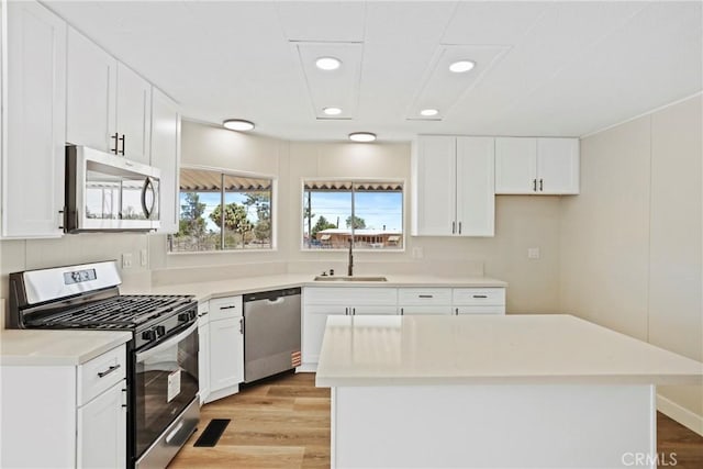 4369 Amador Rd, Phelan, CA 92371 - kitchen featuring stainless steel appliances, light wood-style floors, white cabinetry, light countertops, and recessed lighting