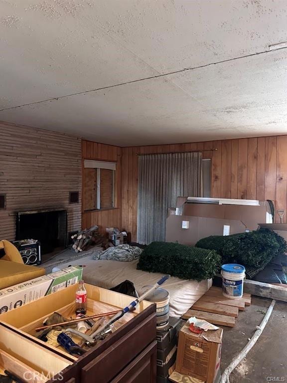 31749 Hilltop Dr, Running Springs, CA 92382 - living area with wood walls, a brick fireplace, and concrete floors