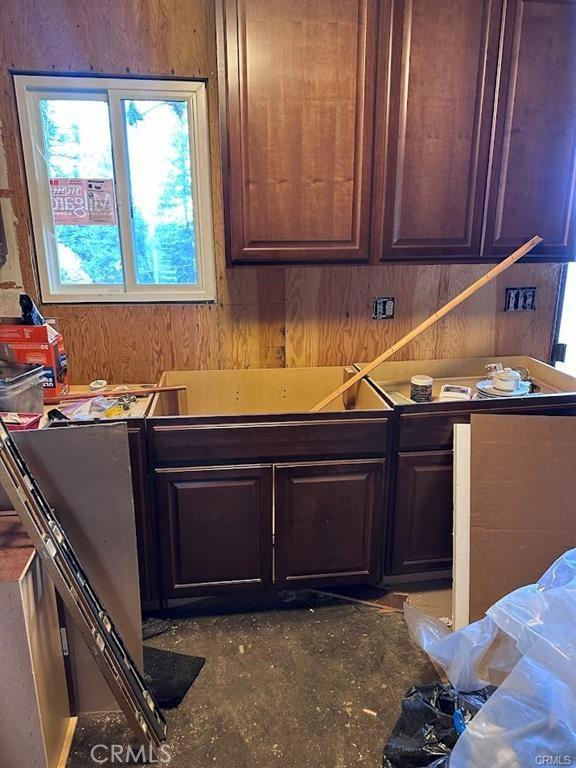 31749 Hilltop Dr, Running Springs, CA 92382 - kitchen featuring wooden walls and concrete flooring