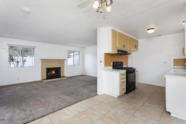1608 Grandview St, Oceanside, CA 92054 - kitchen featuring black gas range, light countertops, light carpet, under cabinet range hood, and a ceiling fan